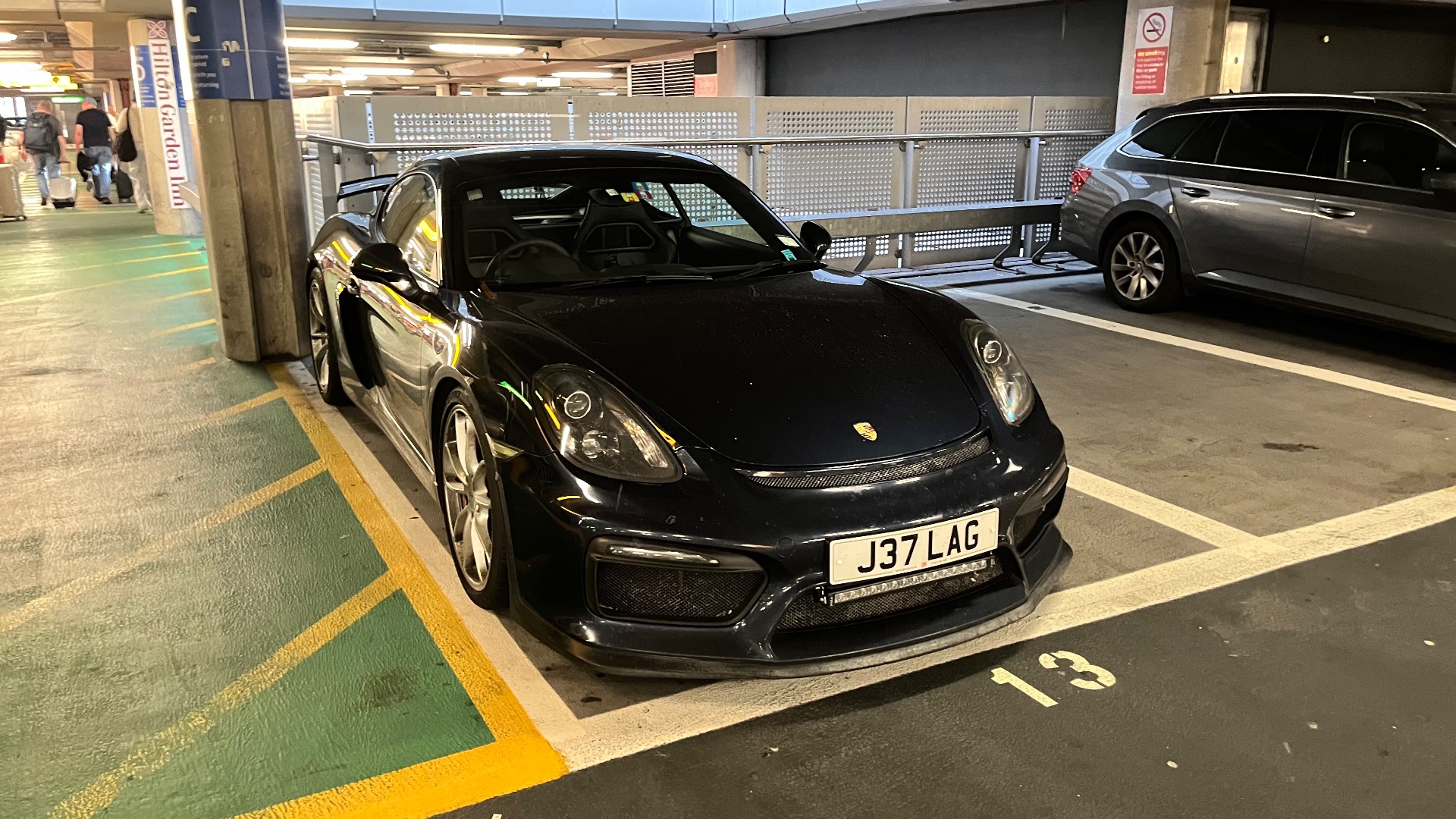 J37 LAG private number plate on a Porsche GT4 Cayman, spotted in Heathrow Airport