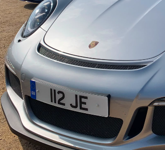 112 JE private number plate on a Porsche